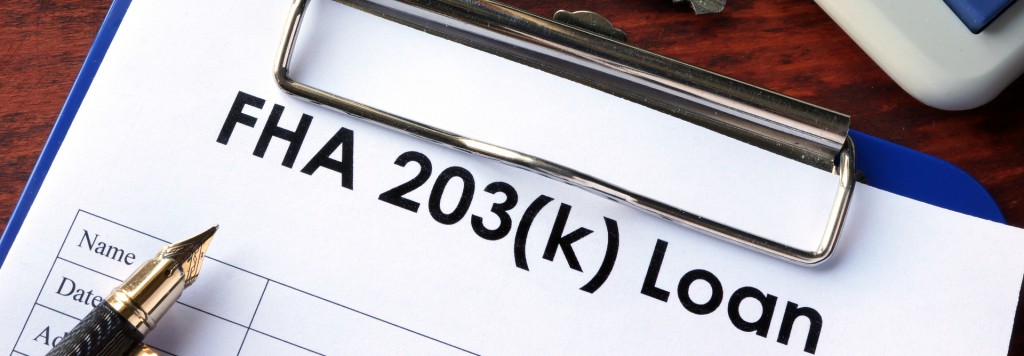 FHA 203(k) Loan on a clip board with a fountain pen and a set of keys next to a calculator